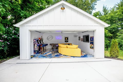 Game room with Golden Tee, NFL Blitz, NBA Jam, big screen tv, and shuffleboard