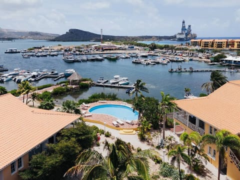 The swimming pool opens up to a wide, breathtaking view of the mountains and ocean, offering a serene and unforgettable setting.