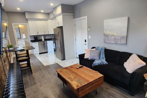 This living room combines modern style with cozy charm, featuring colorful accents, tasteful décor, and plenty of natural light to create a beautiful, welcoming and vibrant atmosphere.