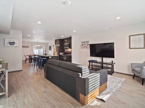 The living space has a sofa and smart TV. The sofa has a trundle bed beneath it (twin) and the sofa seat itself is twin-bed sized.