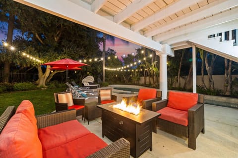 Unwind fireside under the string lights—your private backyard oasis with cozy seating and a pool just steps away. ✨🔥