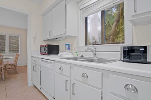 Kitchen freshly repainted and refreshed, featuring a brand-new refrigerator and stove installed in 2025.