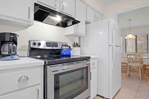 Kitchen freshly repainted and refreshed, featuring a brand-new refrigerator and stove installed in 2025.