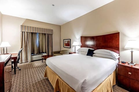 Sink into a king bed with warm, calming lighting.