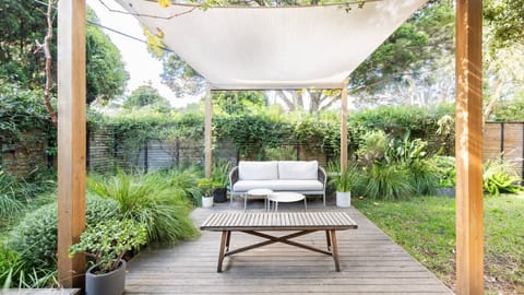 A peaceful outdoor seating area with lush greenery, perfect for relaxation