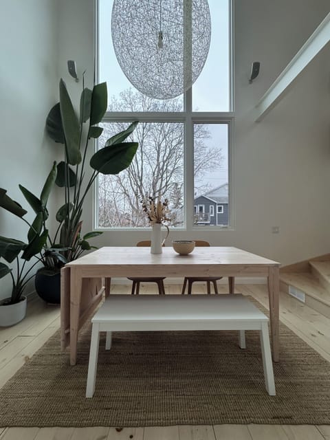Dining room with 18 foot ceilings and picture window looking onto Hintonburg