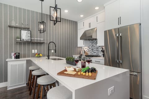 1st Unit (2nd Floor): Fully equipped kitchen with stainless steel appliances and a kitchen island with seating for 4 guests.