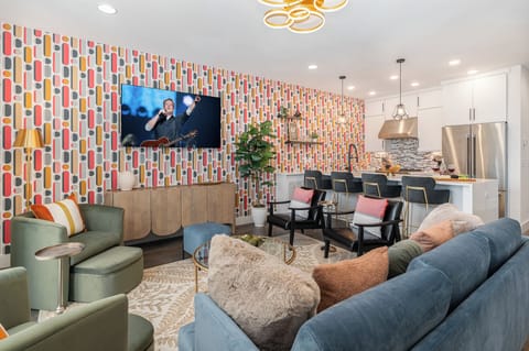 2nd Unit (2nd Floor): Bright and colorful open-concept living area featuring a Smart TV and stylish furnishings.