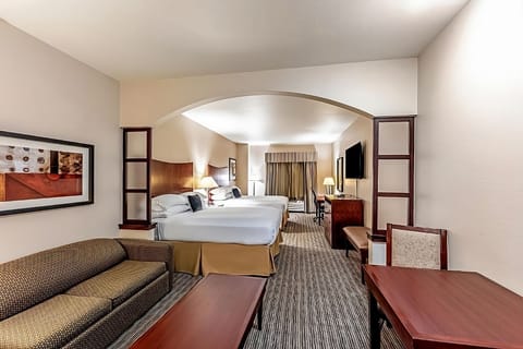 Unwind in a spacious double-queen suite with cozy seating.