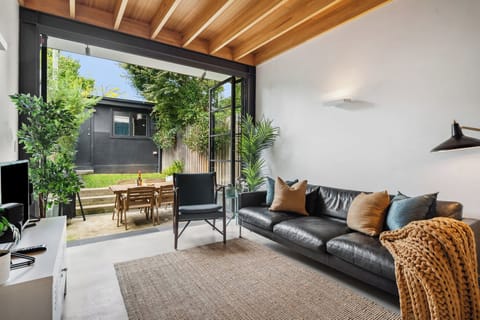Relax in the contemporary living area, which opens effortlessly onto a leafy courtyard with outdoor dining – ideal for enjoying your morning coffee or an alfresco supper beneath the stars.