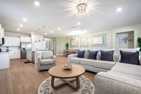 Open-concept living with plush seating, full kitchen, and elegant dining space.
