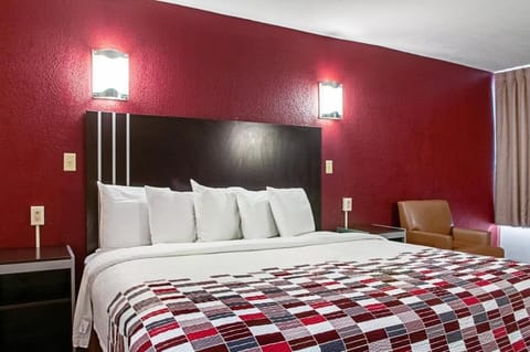 Recharge in a serene king room with warm, calming tones.