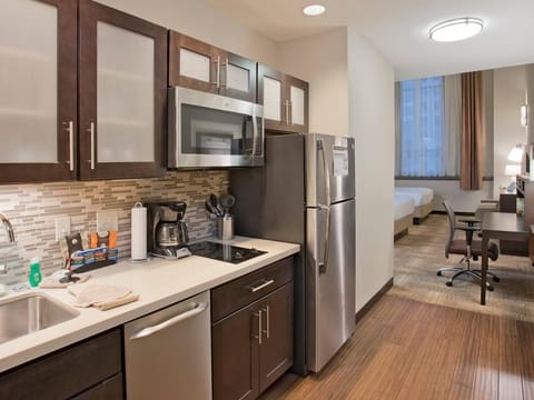 Cook and recharge with a sleek kitchenette and workspace.