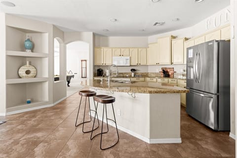 Whip up meals with ease in this fully stocked kitchen—complete with a spacious island and high-top seating for casual bites!