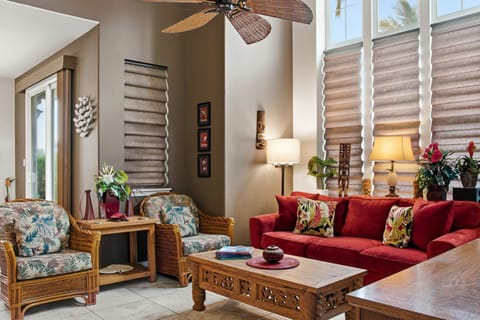 Tropical-themed living room with vibrant decor and natural light.