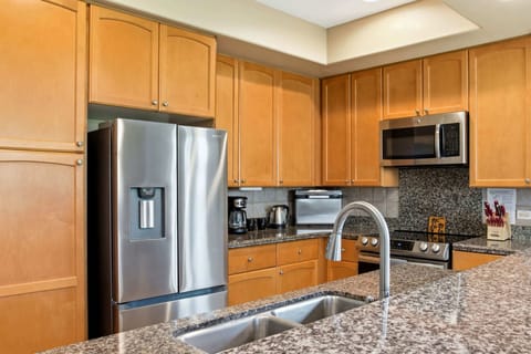 Modern kitchen with granite countertops and stainless steel appliances for gourmet cooking.