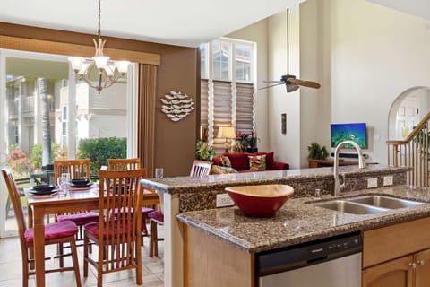 Open-concept kitchen and dining area with garden views and modern amenities.