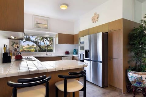 Whip up tropical meals in this spacious kitchen with stainless steel appliances and beautiful views.