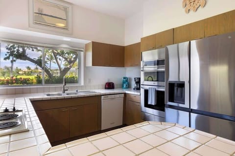 Start your mornings right with coffee in hand and serene greenery framed through the kitchen window.