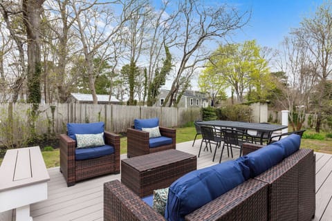 Deck with cozy lounge area, dining table, grill & spatious backyard. 