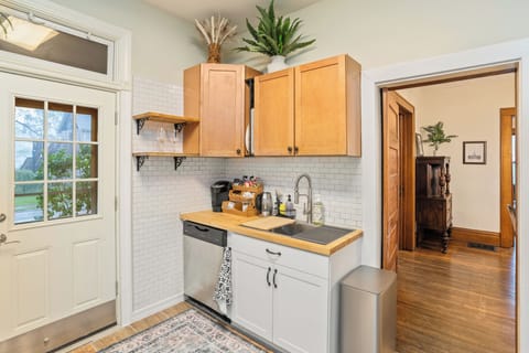 Kitchen with full set of dishes, utencils, cookware and stocked coffee/tea bar.