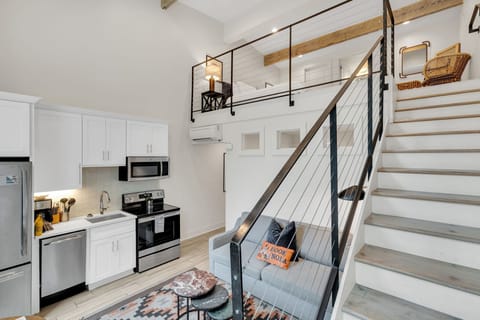 Modern loft-style living with a full kitchen, cozy lounge, and stylish upstairs retreat—your perfect New Orleans getaway.