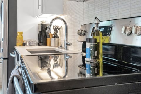 Sleek stove setup with utensils, spices, and cookware at your fingertips.