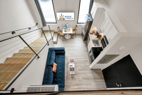 Let the sunshine in through grand-paneled windows that fill the living room with warm, natural light and a view of the historic streets below.