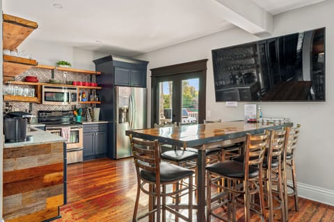 The heart of it all. The open living room/bar/kitchen that opens up to the sky deck. Relax with your friends and family on the huge leather sofa or at the large bar with seating for 9. Watch t