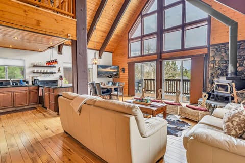 Living room: Main floor, wood-burning fireplace, Samsung Smart TV, deck access