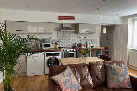 A fully equipped kitchen open-planned to the living room.