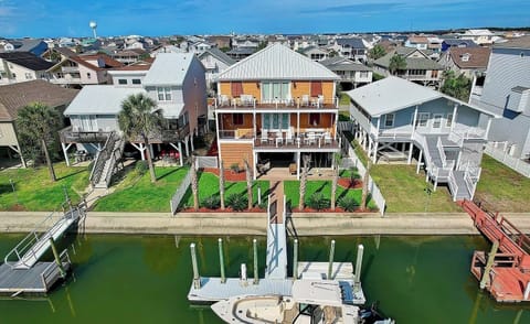 Arial photo of the back of the house located on a canal.   