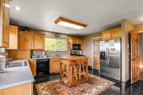 Cook delicious meals in this fully equipped kitchen featuring stainless steel appliances, island seating, and plenty of counter space.