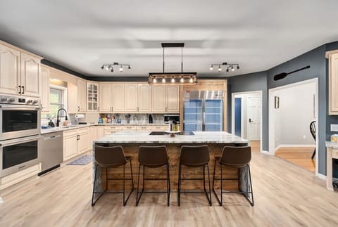 Who doesn't love an 8' custom granite island w/ waterfall edge to gather around!