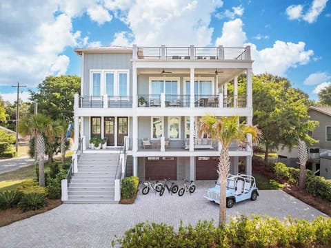 King's Isle features multiple decks front and back, rooftop lounge with OCEAN VIEW, (3) E-bikes, pool and hot tub, outdoor bar, and MOKE low speed vehicle. 