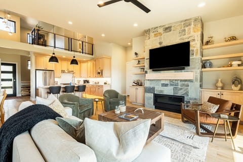 Living Room with TV, Balcony Access, Gas Fireplace, & remote blinds throughout