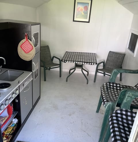 Inside playhouse with kitchen and tons of play food and cooking supplies