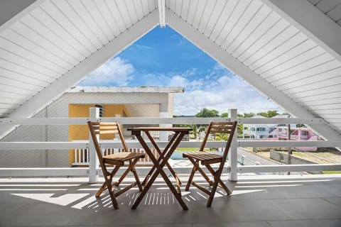 Perfect Balcony for Outdoor Dining. This balcony features a cozy table and chairs, creating an ideal setting for outdoor meals with a view.