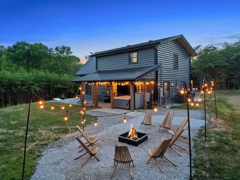 Cozy modern cabin with fire pit, string lights, and peaceful forest views, perfect for relaxing nights and unforgettable getaways.