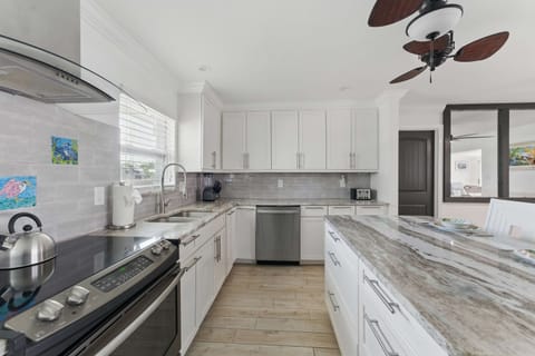 Cook like a pro in this modern kitchen featuring a wide, spacious counter perfect for meal prep or casual dining. With a convenient dishwasher, cleanup is a breeze, leaving you more time to relax and enjoy your stay.
