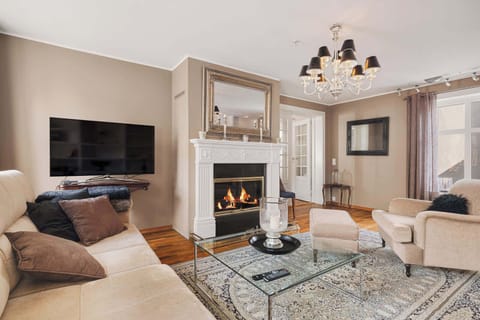 Cozy up in your dream living room! Imagine the warmth of the fireplace and the comfort of the couch.