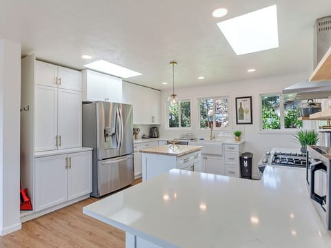Fully stocked modern kitchen with stainless appliances and abundant counter space