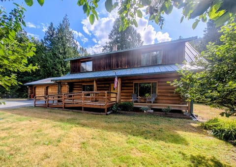 Beautiful custom log home boast parking for up to 4 vehicles and EV charger.