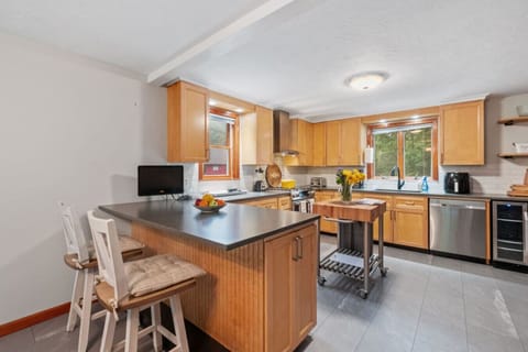 Sunny kitchen offering plenty of counter space, a breakfast bar, and dining seating — ideal for families and group meals.