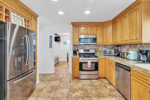 Fully equipped kitchen with an array of appliances including air fryer, ninja blender and more.