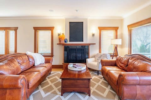 Living room with leather couches and cozy gas fireplace.