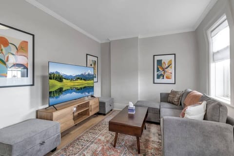 Comfortable living room with a couch that can have additional cushions added to it to become a double bed