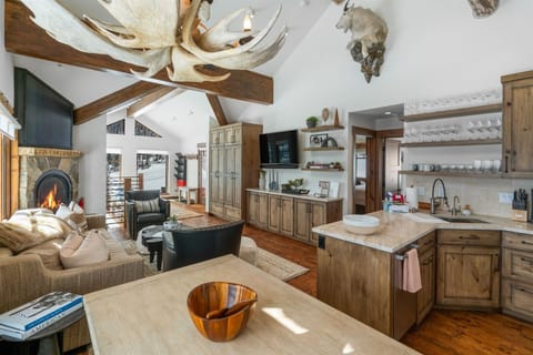 Kitchen, dining, and living room with custom cabinets and heated hardwood floors