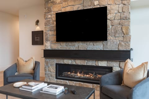 Cozy up by the stone fireplace and enjoy a movie night on the large smart TV.