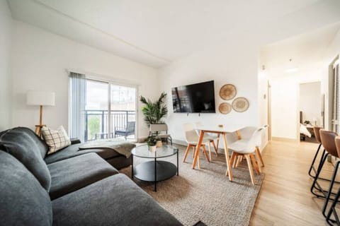 The living room’s plush seating beckons you to sink in and relax, surrounded by light and airy decor.